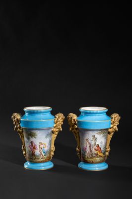 pair of blue and gold vases with figures on them