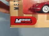 someone is holding a red model of a car in a cardboard box