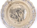 a plate with a picture of a man and a woman on it