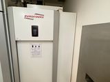 two refrigerators that are in a room with tile flooring