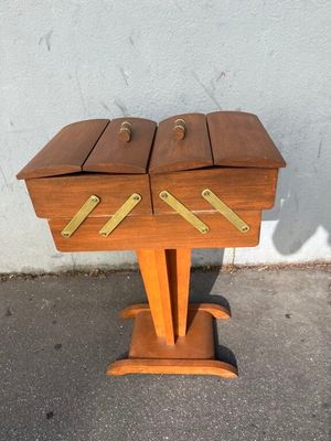 a small wooden table with two drawers on top of it