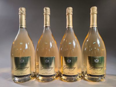 four bottles of wine are lined up on a table