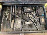 many tools in a tool box on the floor