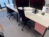 two computer monitors on the desk in the office