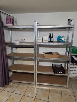 a room with shelves and a shower curtain in it