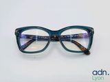 glasses with blue frames on a white surface with a blue background