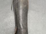 someone is holding a pair of boots in their hand