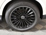 a close up of a tire on a white car