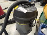 a vacuum that is sitting on the floor in a room