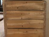 a wooden chest of drawers sitting on a table