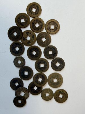 a lot of coins that are on a white surface