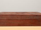 an old wooden box sitting on top of a wooden table