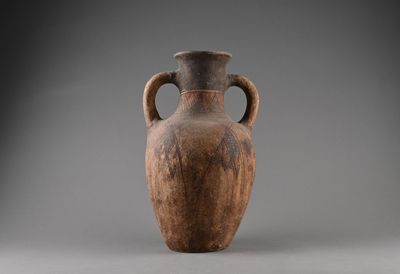 a brown vase that is sitting on a table