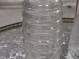 a bottle of water sitting on a table next to a bottle of water
