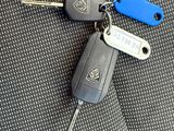 a car key and a keychain on the seat of a car
