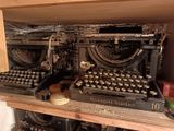 an old typewriter sitting on a shelf in a room