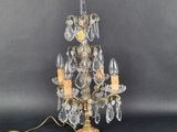 a close up of a gold and crystal chandelier on a black background
