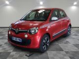 the small red car is parked in a large room