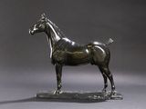 statue en bronze représentant un cheval sur un socle en bois, sur fond gris