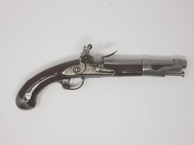 an old gun on a white surface