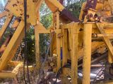 a large yellow machine that is sitting in the dirt