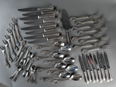 a lot of silver spoons and forks laid out on a table