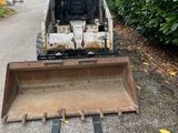 an image of a small bulldozer parked on the side of the road