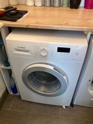 a washer and a dryer in a small room