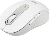 the computer mouse is white and has a green button