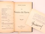 an open book sitting on top of a table next to a piece of paper