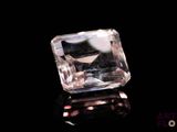 a close up of a clear crystal stone on a black surface