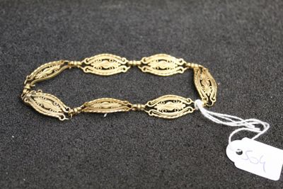 a close up of a gold bracelet with a tag on it
