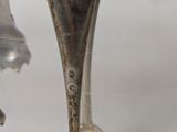 a silver plate with a silver spoon and fork on it