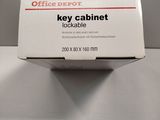 a box of office depot key cabinet sitting on a table