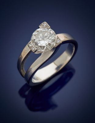 an engagement ring with a round brilliant cut diamond set in 18k white gold