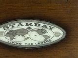 a picture of a star ray logo on a wooden cabinet