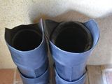 a pair of blue rain boots sitting on a tile floor