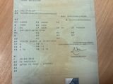 a receipt with a picture of a man on it on a table