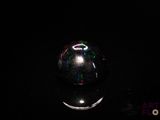 a close up of a glass ball on a black surface