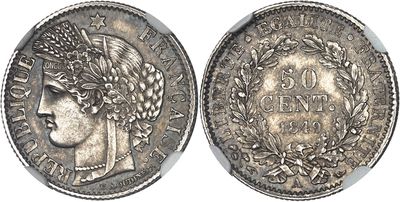 a silver coin with a woman ' s head and laurels on it