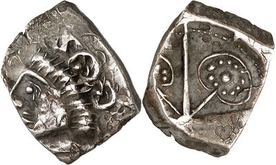 a close up of two silver coins on a white surface