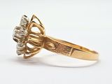 an image of a gold ring with a diamond center stone