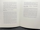 an open book sitting on top of a table next to a black background