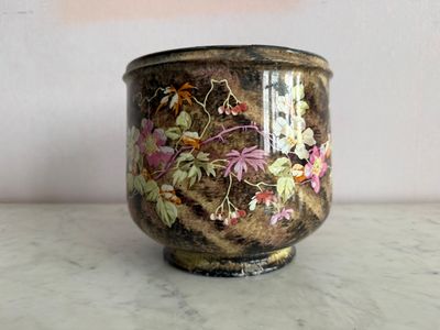 a vase with a floral design on it on a table