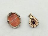 a close up of two different pieces of jewelry on a table