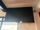 a flat screen tv mounted on the wall above a window