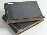 two books stacked on top of each other on a table