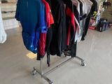 a lot of clothes hanging on a rack in a store