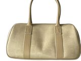gold leather handbag on white background with clipping for text