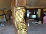 a wooden table with a gold head on it